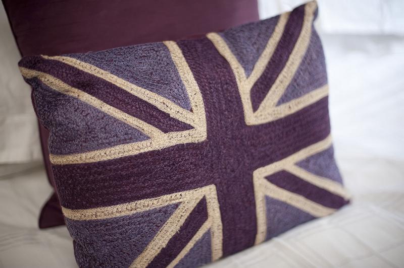 Free Stock Photo: British themed bedroom with a colorful cushion bearing the Union Jack or Union Flag of the United Kingdom, close up of the cushion or pillow on the bed