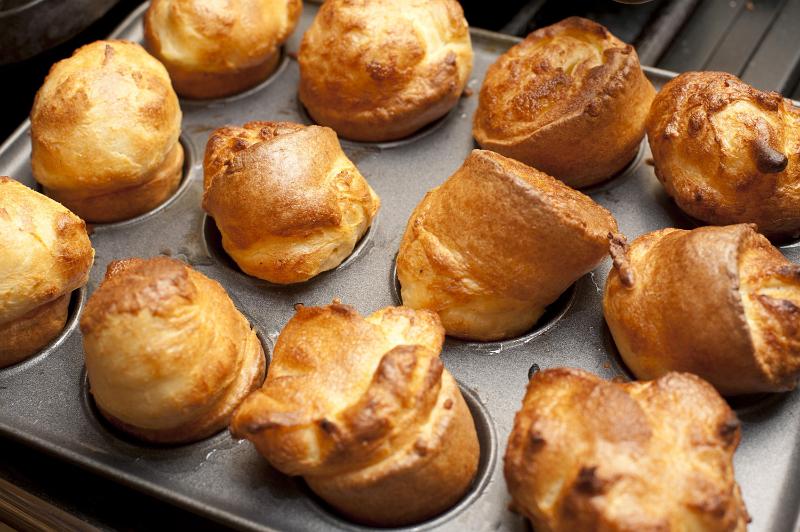 Free Stock Photo: Delicious small individual light puffy Yorkshire Puddings made from batter in a baking tray ready to be served as an accompaniment to roast beef
