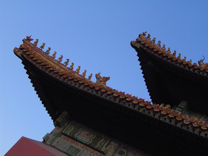 Free Stock Photo: Architectural detail of the roof of a building or pagoda in the Forbidden City, Beijing, China against a clear blue sky in a travel concept