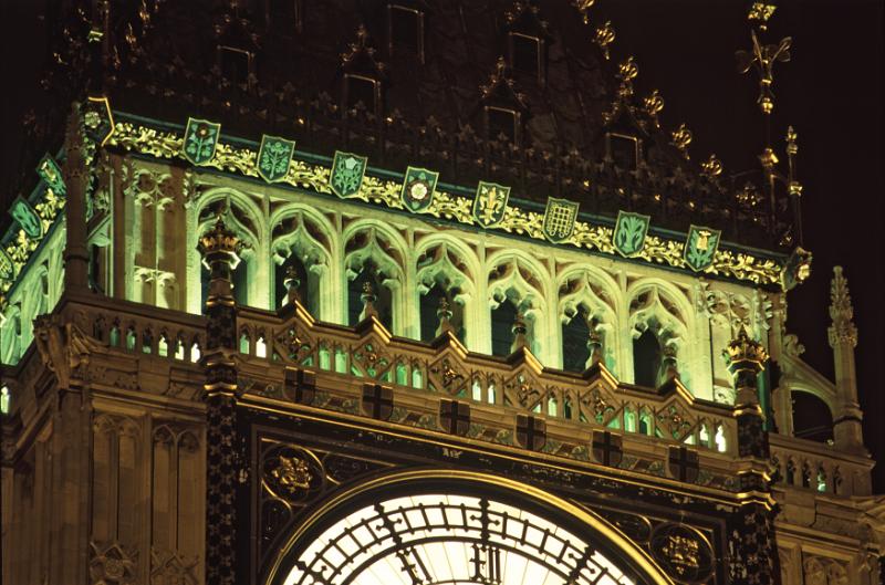 Free Stock Photo: Close up detail of Big Ben, London, at night showing the illuminated Gothic windows above the clock face