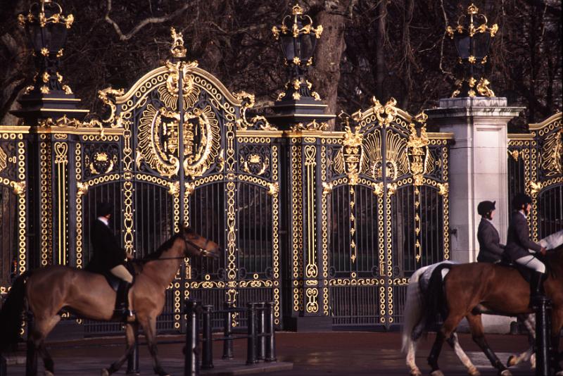 Free Stock Photo: Equestrian Riders on Horseback Riding Past Ornate Golden Gates of Buckingham Palace, City of Westminster, London, England