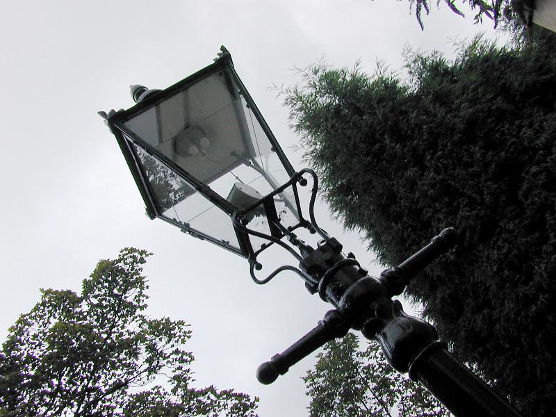Free Stock Photo: Old Victorian cast iron gas lamp in an urban street viewed from below diagonally through the frame