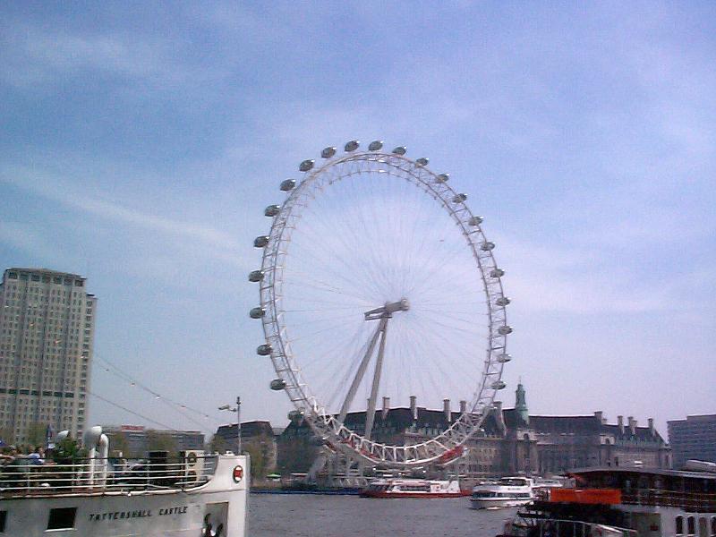 Free Stock Photo: London Eye ferris wheel on the bank of the River Thames in London with its ovoid gondolas for passengers from which to view and observe the city