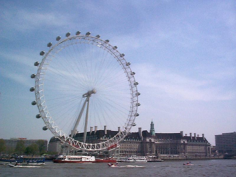 Free Stock Photo: London Eye ferris wheel on the bank of the River Thames with its ovoid shaped passenger gondolas which permit tourists to view and observe the city