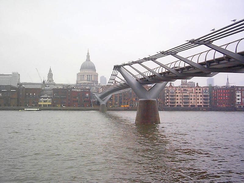 Free Stock Photo: Low angle view from the water of the Millennium Bridge, London, crossing the River Thames with St Paul's Cathedral in the background on an overcast day