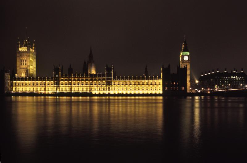 Free Stock Photo: Palace of Westminster, the Houses of Parliament and Big Ben on the bank of the River Thames, London, illuminated at night and reflected in the river below