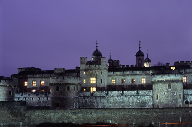 Free Stock Photo: Tower of London with illuminated windows at night against a deep blue twilight sky, a popular historical British tourist attraction