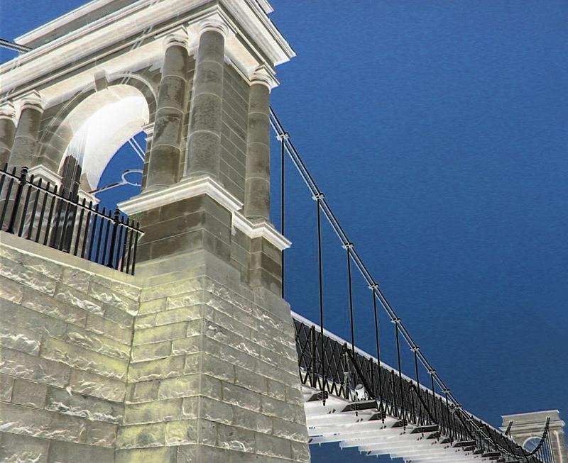 Free Stock Photo: Stone support tower on a suspension bridge viewed from below looking up against a blue sky