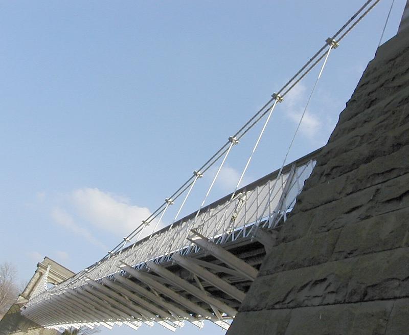 Free Stock Photo: Oblique angle view of the cables and towers of a suspension bridge viewed from below against a blue sky