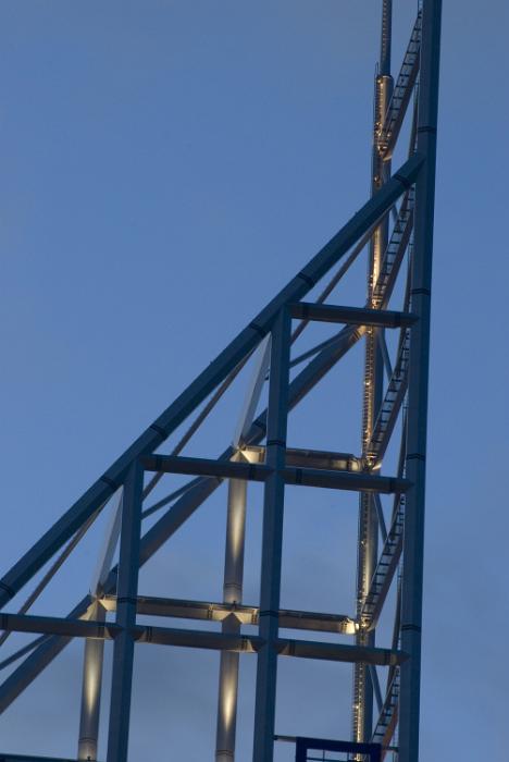 Free Stock Photo: High-rise architecture metal building spire with an open-sided triangular design against a blue sky