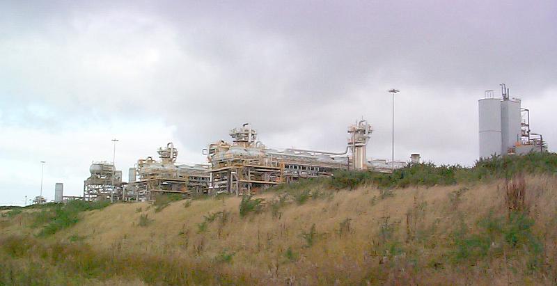 Free Stock Photo: View of a large gas terminal on marshland with a stormy sky