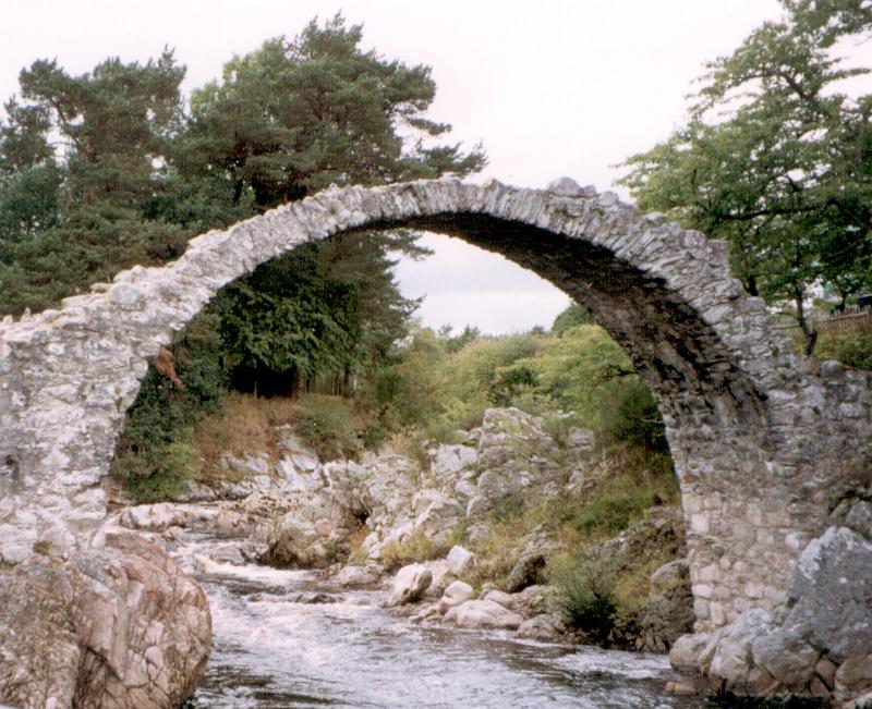 Free Stock Photo: Old stone arch bridge across narrow river in nature landscape