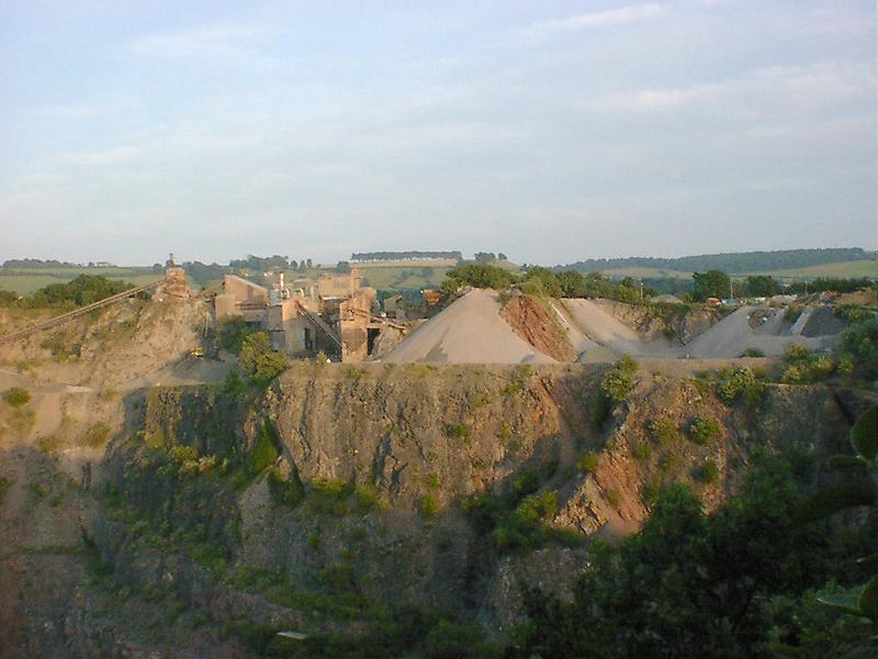 Free Stock Photo: Rural open cast quarry mining natural resources with stacks of gravel and crushed rock