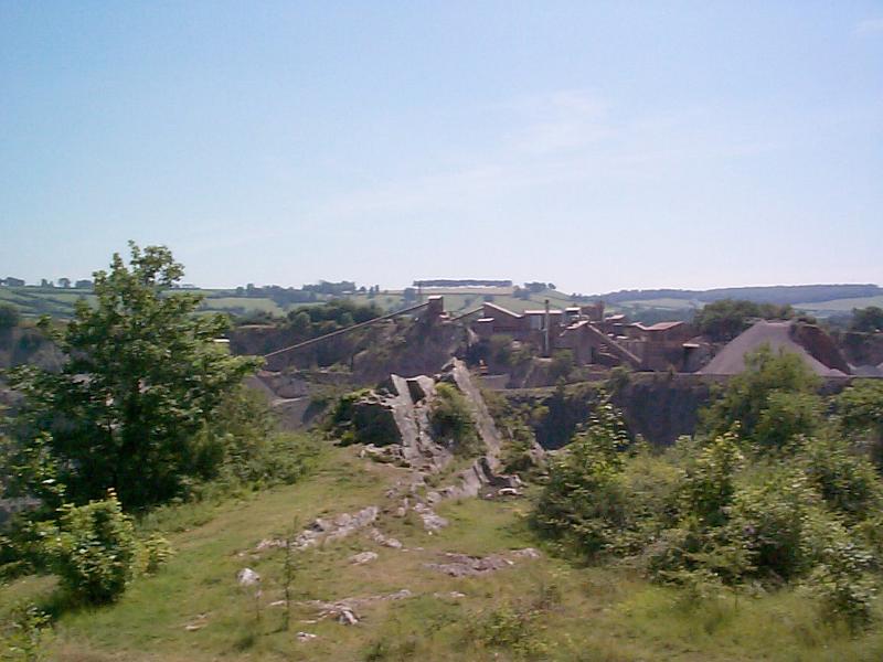 Free Stock Photo: Industrial open cast quarry mining rock in the countryside in a long distance view of the machinery and equipment