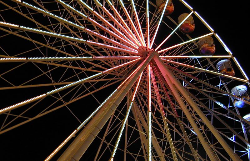 Free Stock Photo: Closeup cropped view of a large ferris wheel illuminated at night at an amusement park