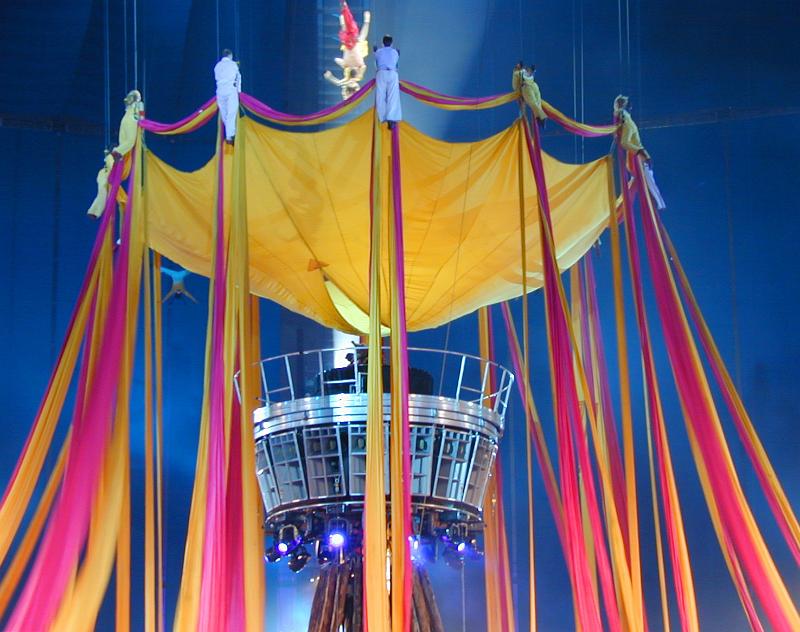 Free Stock Photo: Acrobats performing during a live circus show on a colorful centre stage festooned with ribbons
