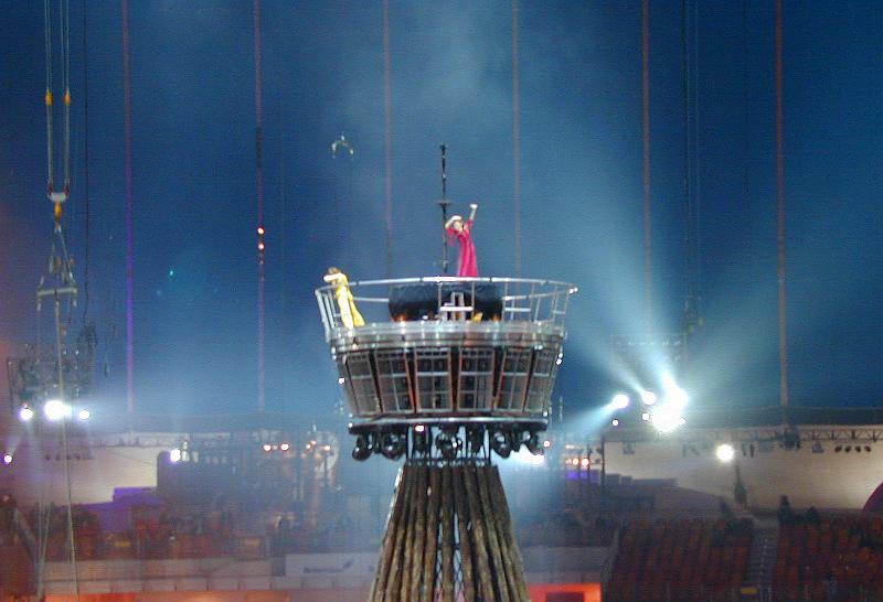 Free Stock Photo: Performers in a circus show on an elevated centre stage illuminated by bright spotlights during their act