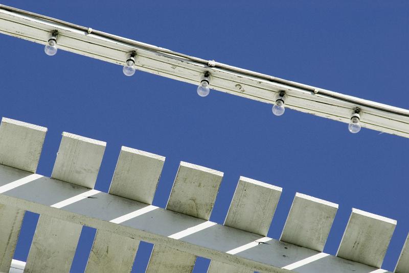Free Stock Photo: A close up of amusement park lighting during daytime with a blue sky background.