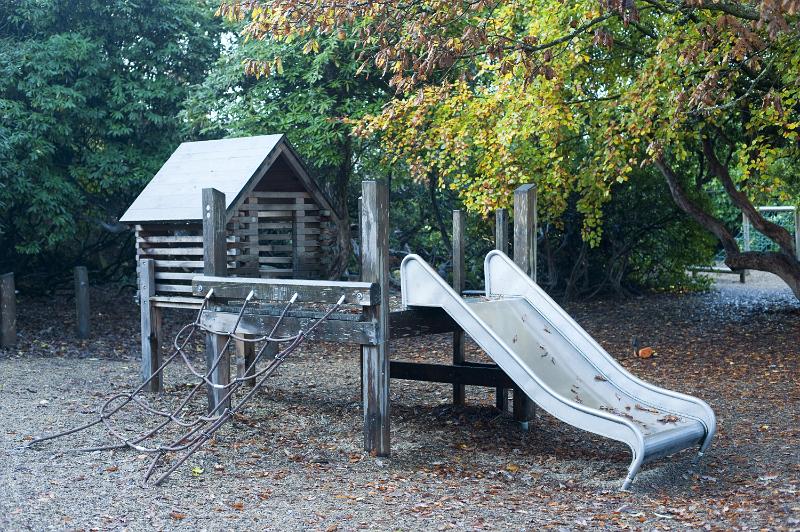 Free Stock Photo: Kids playground with slide and climbing net under leafy green trees in autumn