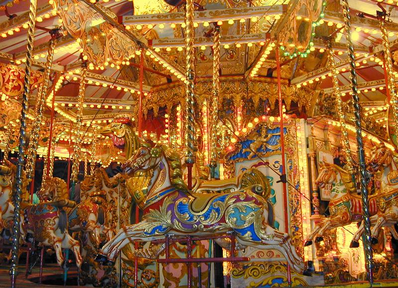 Free Stock Photo: A close up of an exotic amusement park carousel, lit up at night.