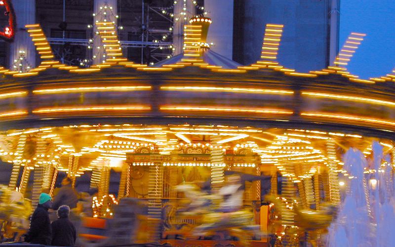 Free Stock Photo: Motion blur of a festive merry-go-round or carousel illuminated at dusk on a fairground or amusement park
