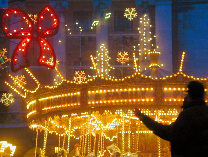 Free Stock Photo: A Christmas themed amusement park at night lit with neon lighting.