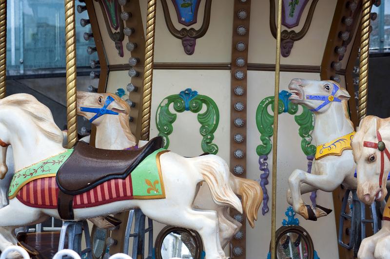 Free Stock Photo: Colorful decorative horses on a carousel or merry-go-round at an amusement park in a close up view