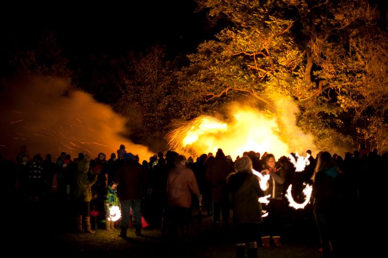 Free Stock Photo: Crowds of people gathered around a blazing bonfire celebrating Bonfire Night or Guy Fawkes on the 5th November