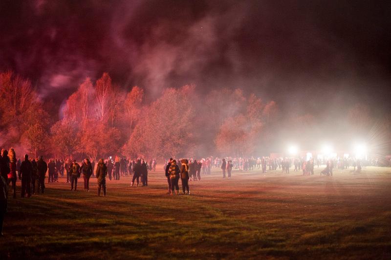 Free Stock Photo: Spectators at a Bonfire Night event gathered in an open field in smoke filled air from the exploding fireworks