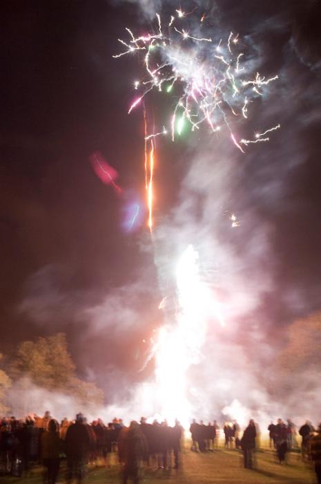 Free Stock Photo: Crowd of people standing in a field watching a fireworks display and bonfire on Bonefire Night or Guy Fawkes on th 5th November