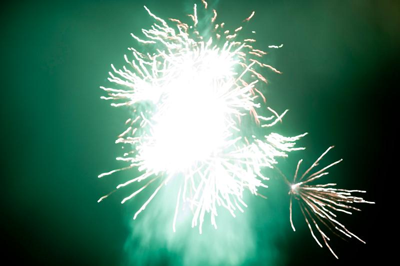 Free Stock Photo: Bright fiery explosion of green fireworks in a dark night sky to celebrate a festival of special event