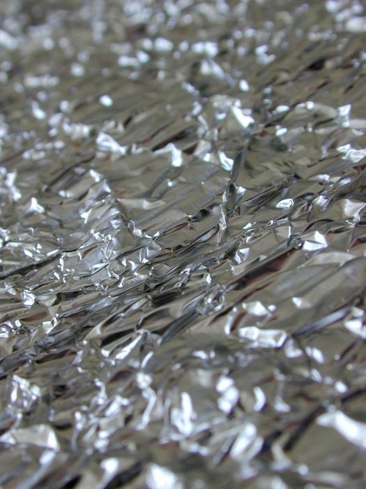 Free Stock Photo: Festive background of crumpled metallic silver foil viewed obliquely to enhance the texture