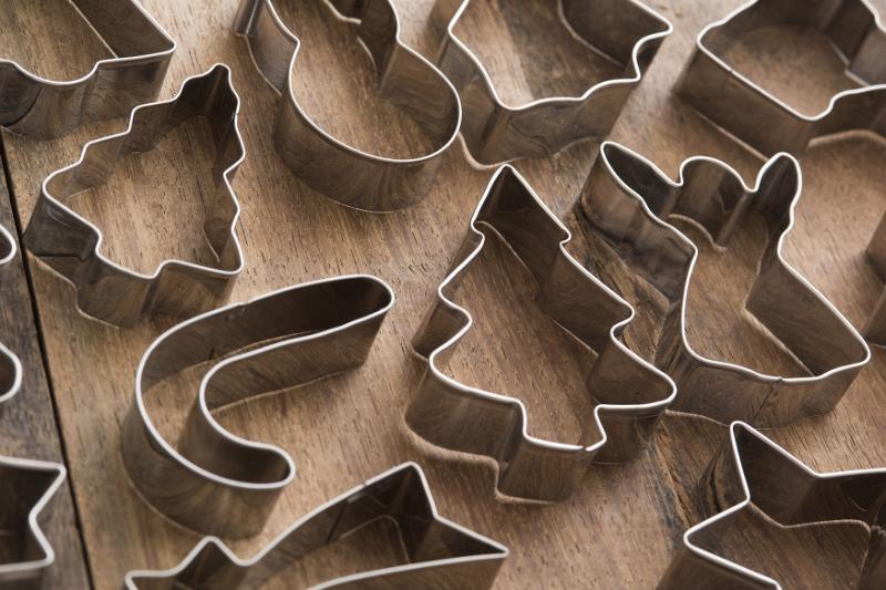 Download image of Christmas background of assorted cookie cutters Free Stock Photo: Christmas background of assorted cookie cutters arranged on a wooden table viewed high angle full frame