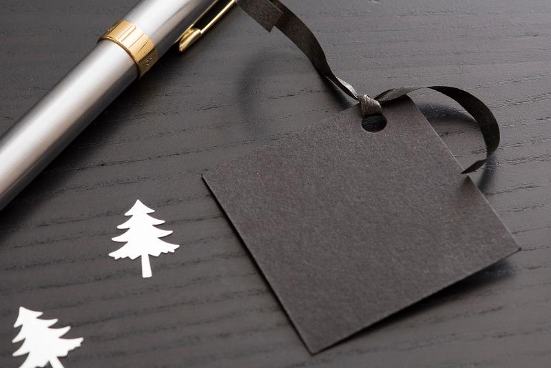 Free Stock Photo: concept image of writing a gift label, a tag and pen with space for text on black background