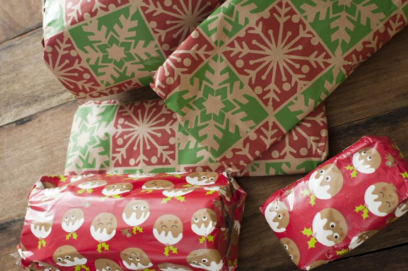 Free Stock Photo: Colorful selection of gift wrapped Christmas presents in boxes on a wooden table or floor