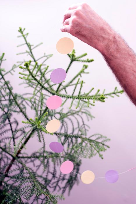 Free Stock Photo: close up on a hande decorating a christmas tree with paper garlands