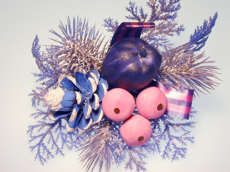 Free Stock Photo: A Silver coloured decortative christmas sprig with pink and purple coloured berries and balls