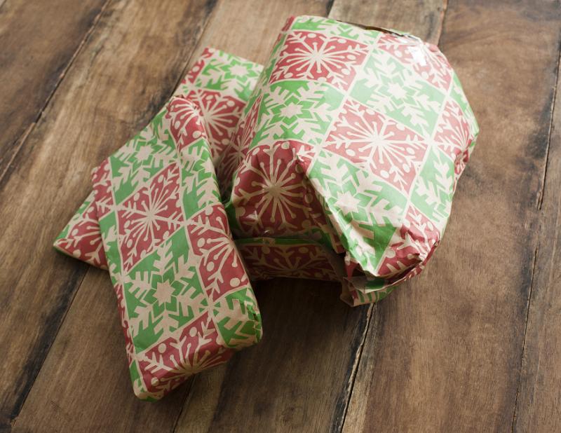 Free Stock Photo: Pile of festive Christmas gifts in colorful wrapping on a wooden table viewed high angle