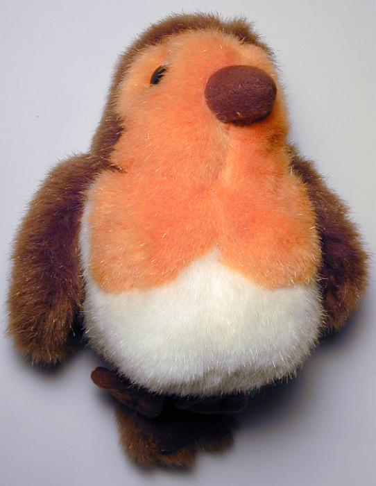 Free Stock Photo: High Angle View of Fuzzy Robin Song Bird Childs Toy Lying on Back on White Background