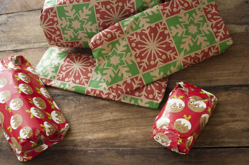 Free Stock Photo: Pile of colourful wrapped Christmas presents or gifts on a wooden floor ready for Xmas morning
