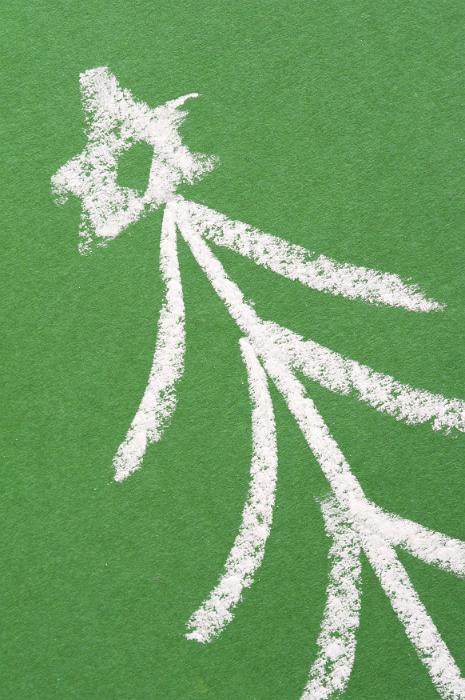 Free Stock Photo: Hand-drawn chalk Christmas tree on a green blackboard topped with a decorative star for a simple Xmas background