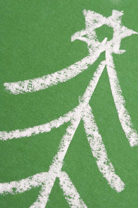 Free Stock Photo: Hand-drawn Christmas tree topped with star sketch at a diagonal on a green chalkboard, close up view