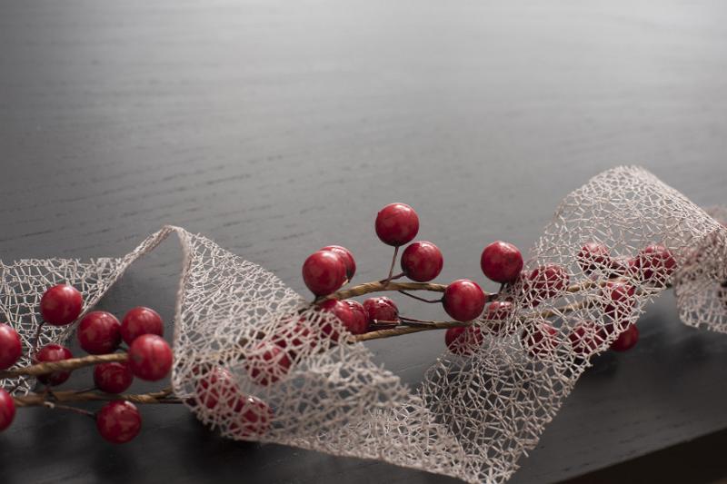 Free Stock Photo: Pretty dainty see through Xmas ribbon with red berries forming a bottom border with copy space to celebrate Christmas