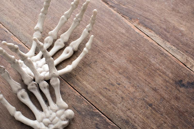 Free Stock Photo: halloween boney hands on a rustic wooden backdrop