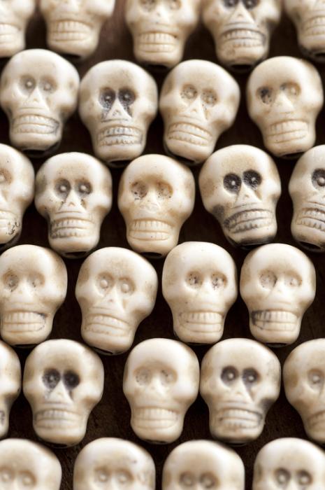 Free Stock Photo: Bunch of tiny spooky looking plastic skull toys for Halloween theme. Includes copy space.