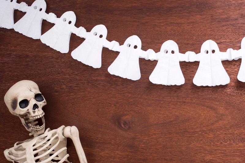Free Stock Photo: a halloween background featuring a skeleton and a string of ghosts