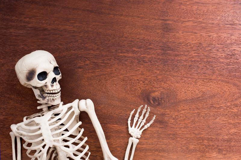 Free Stock Photo: a fun halloween skeleton background with a waving hand and space for a message
