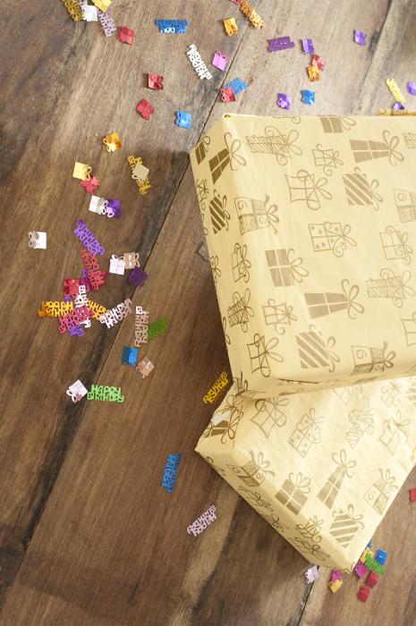 Free Stock Photo: a wooden surface with birthday decoration sprinkles and two wrapped presents