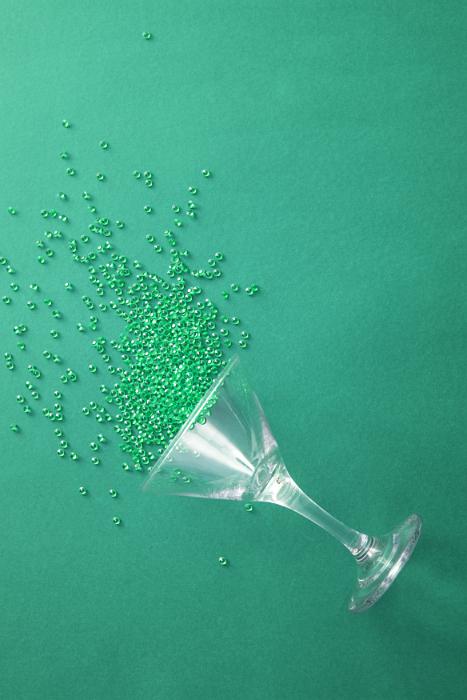 Free Stock Photo: Colorful green cocktail background with copy space conceptual of a party with sprinkled beads spilling from an upturned martini glass