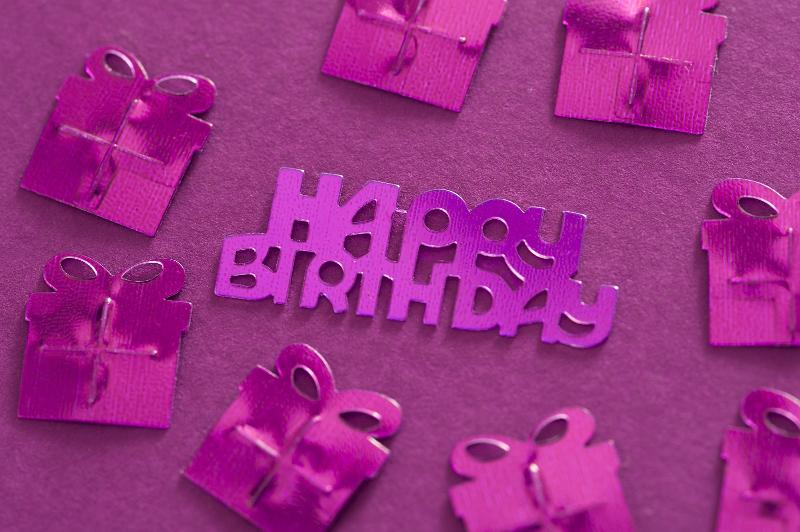 Free Stock Photo: Fuchsia Gift Shaped Foil Confetti Arranged Around Happy Birthday Message on Fuchsia Background